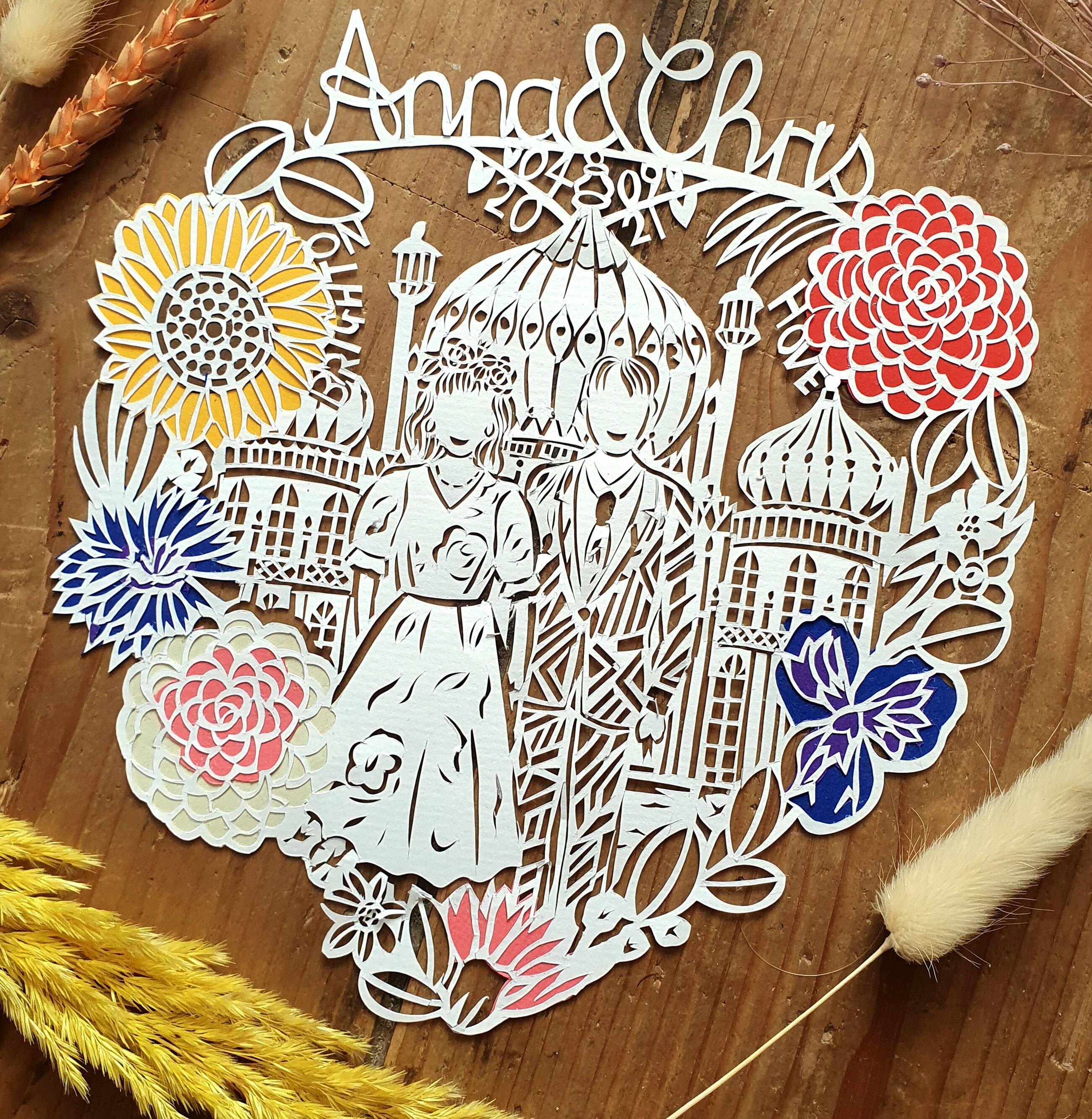 Wedding paper cut featuring bride and groom at Brighton Pavillion, with flowers around the outside