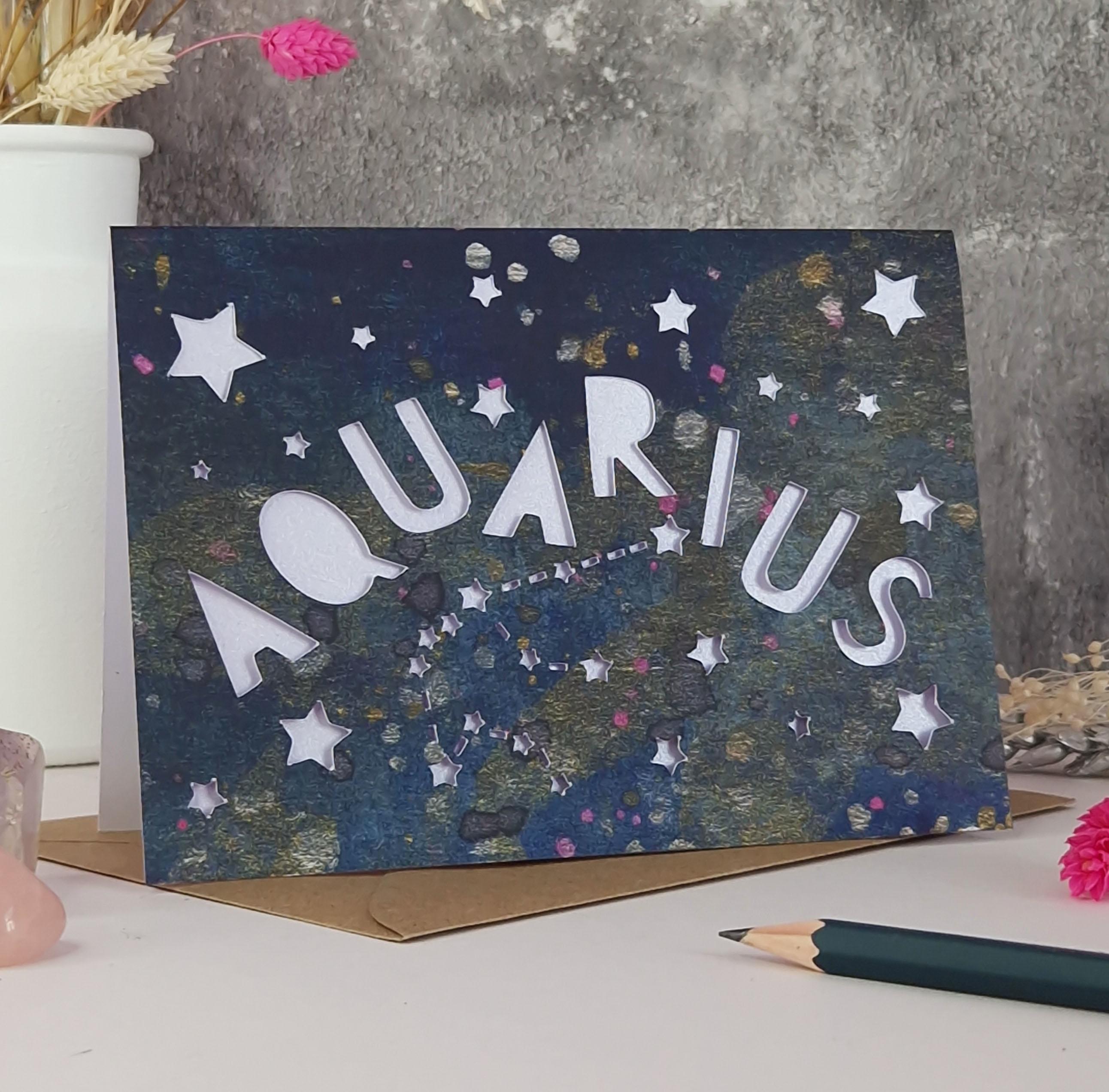 Midnight Blue printed card with papercut text that says 'Aquarius' and a lilac pearl liner