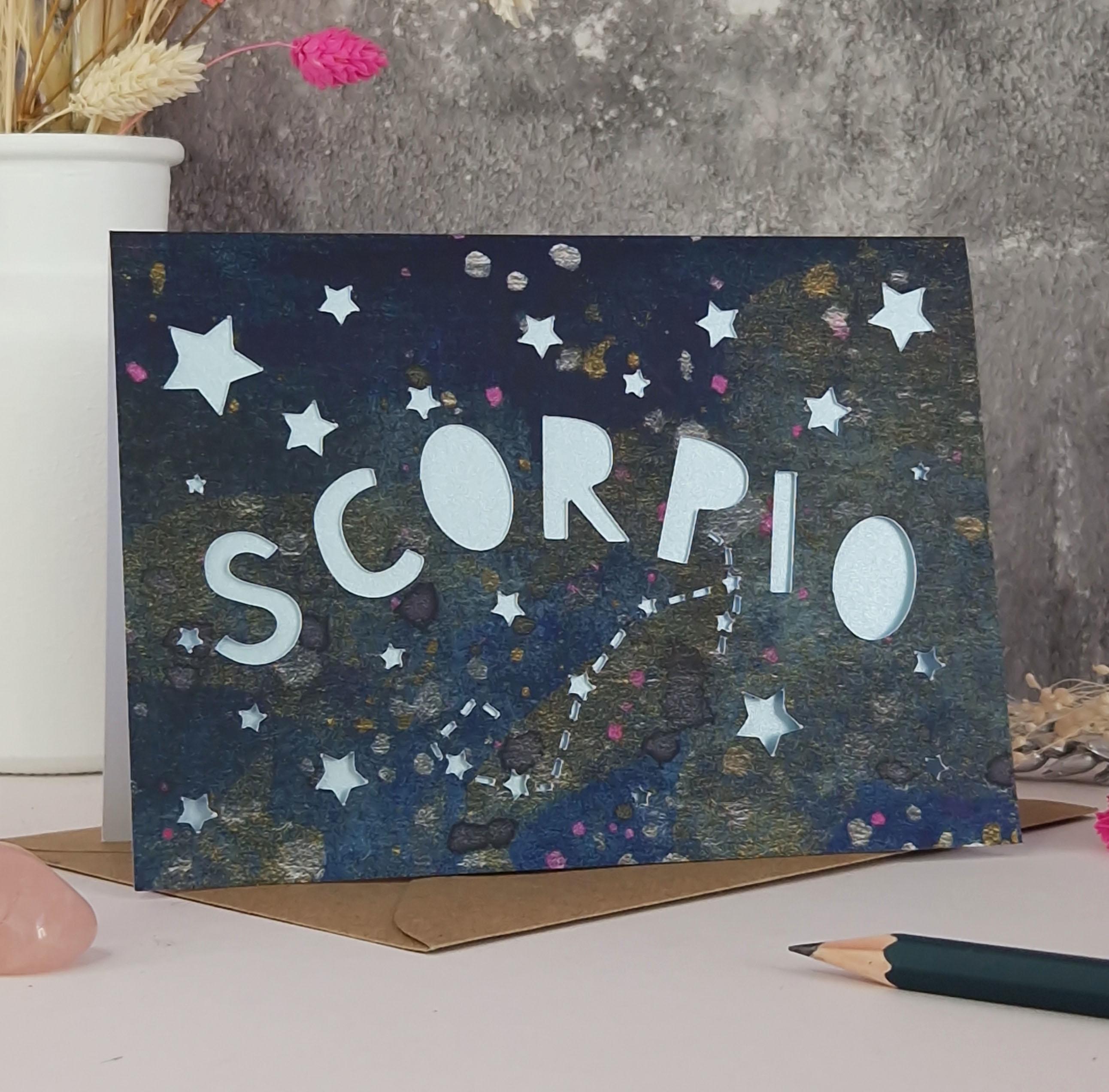 Midnight Blue printed card with papercut text that says 'Scorpio' and a light blue pearl liner