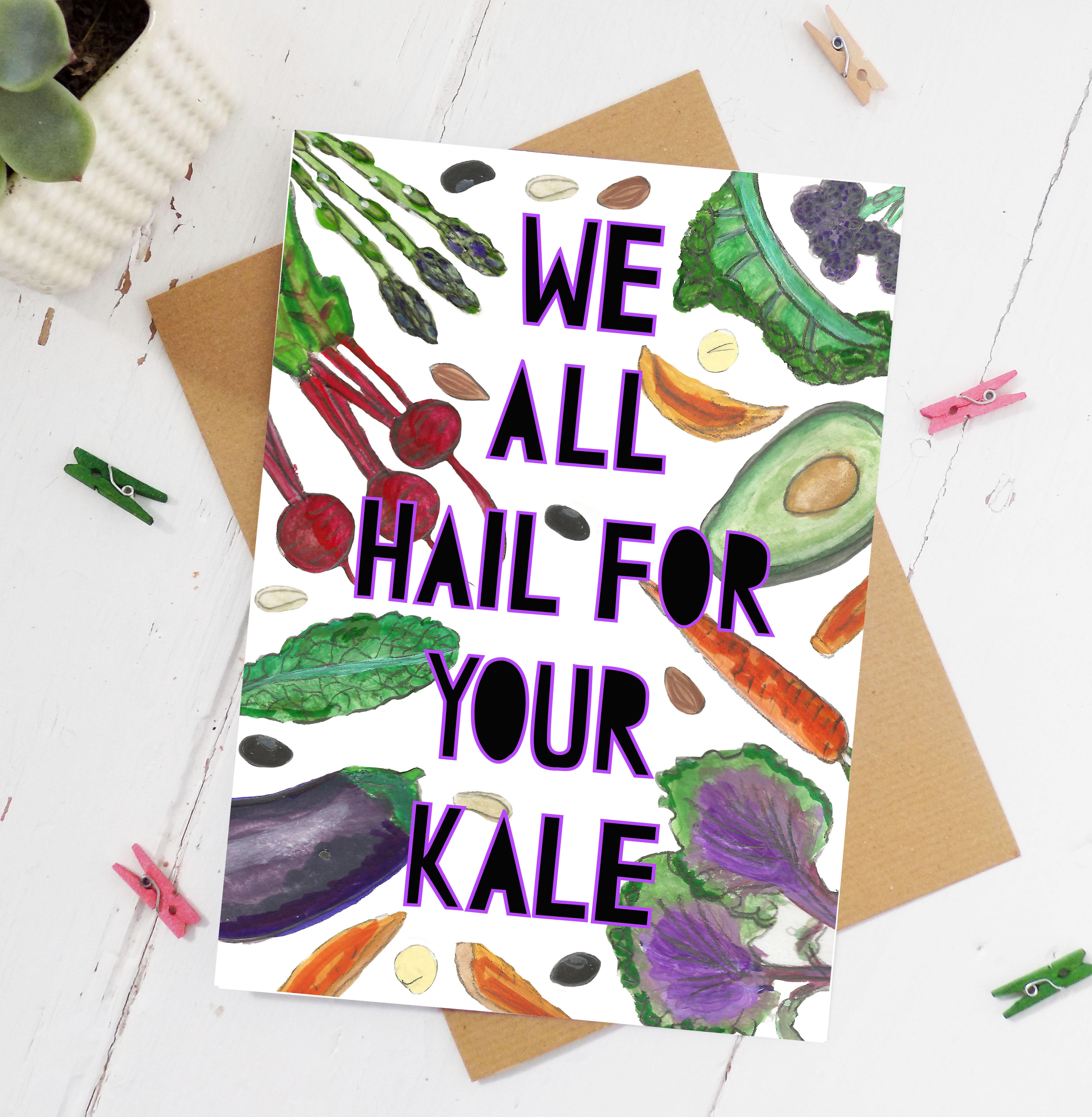 Watercolour illustrations of different vegetables with paper cut typography cut out from top to bottom saying 'we all hail for your kale'