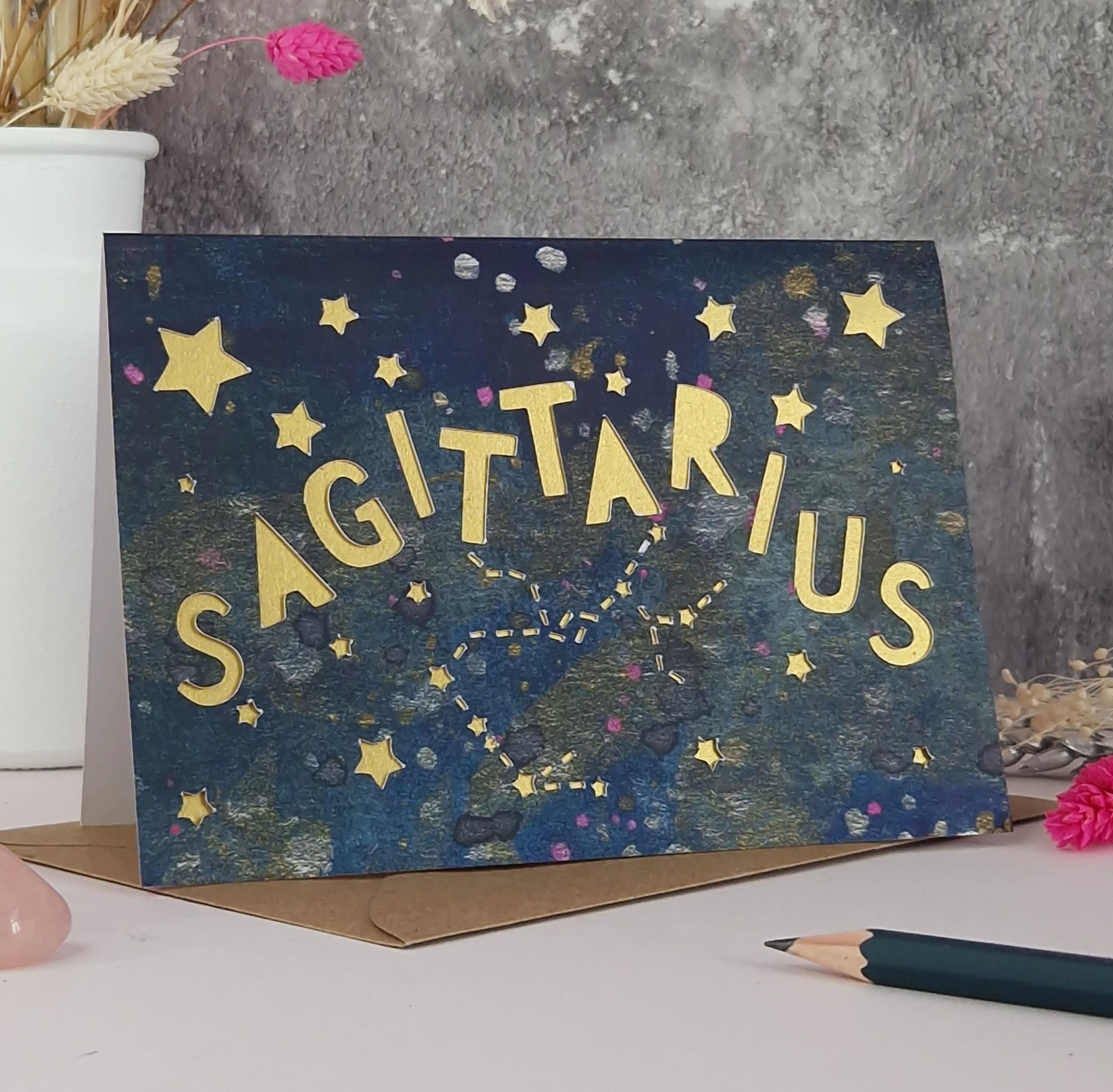 Midnight Blue printed card with papercut text that says 'Sagittarius' and a gold pearl liner