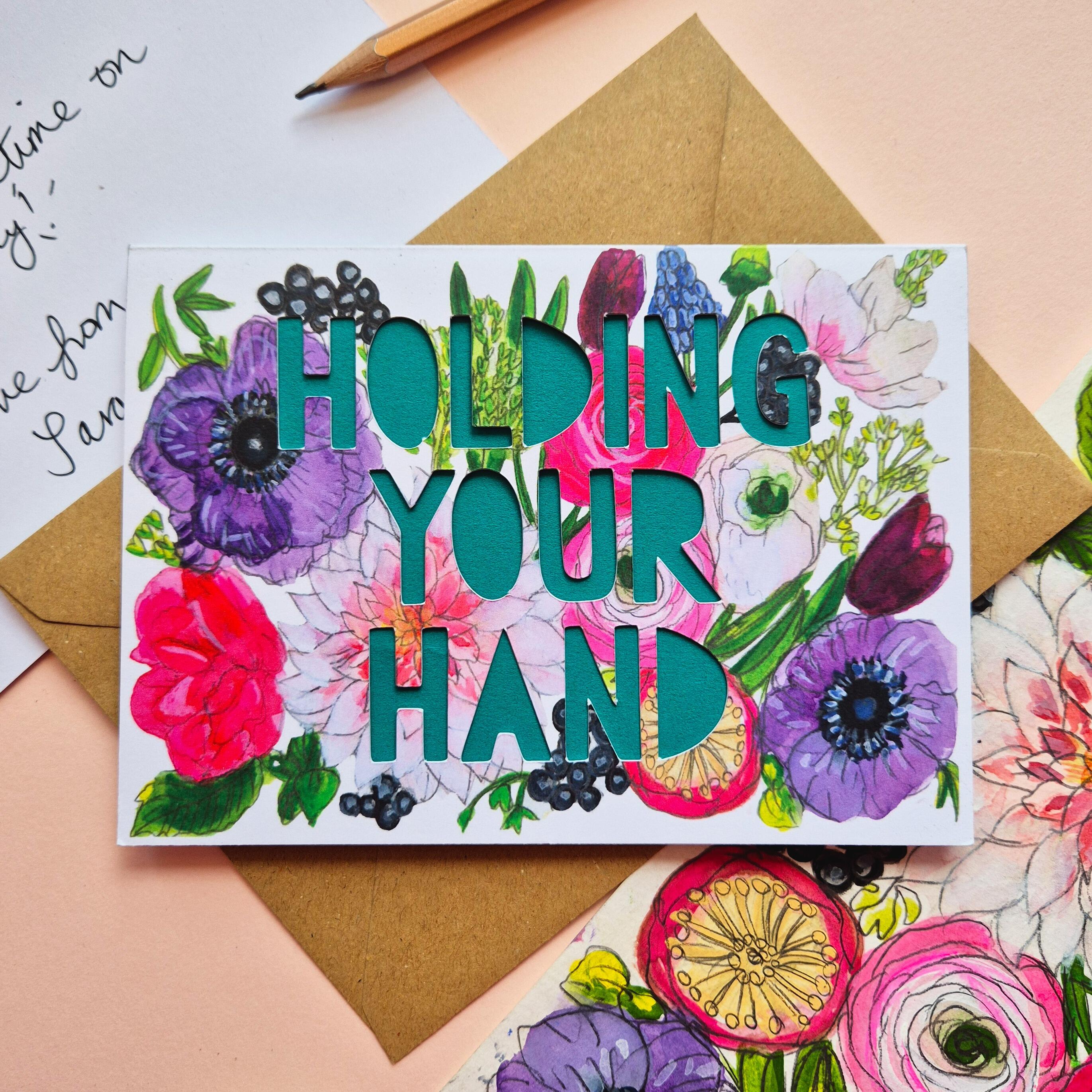 Bright floral illustration card with Holding Your Hand paper cut text and green paper liner