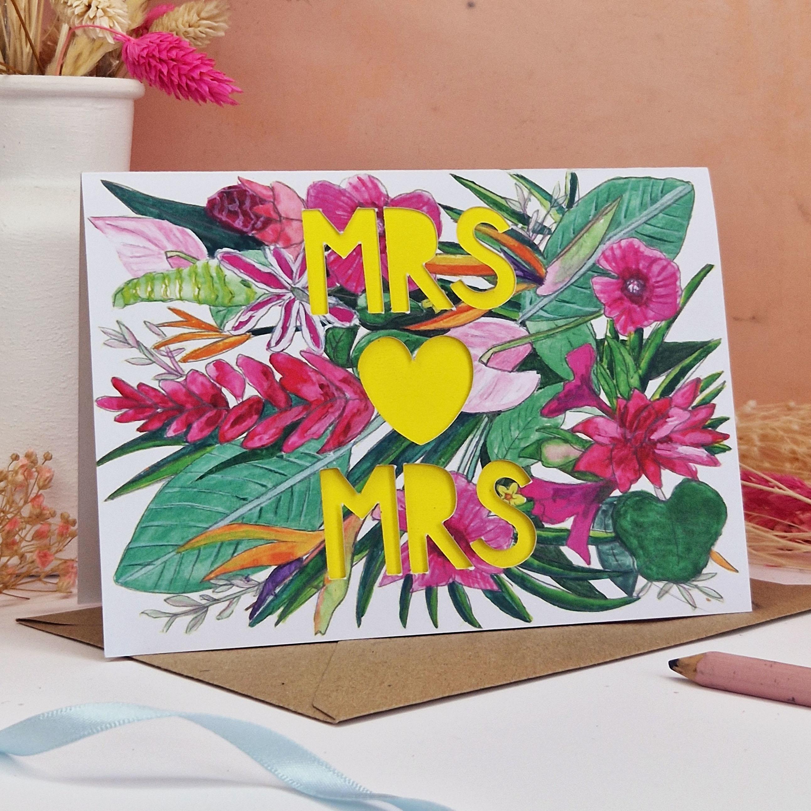 Floral Card with Paper cut text that says Mrs and Mrs with bright floral background.