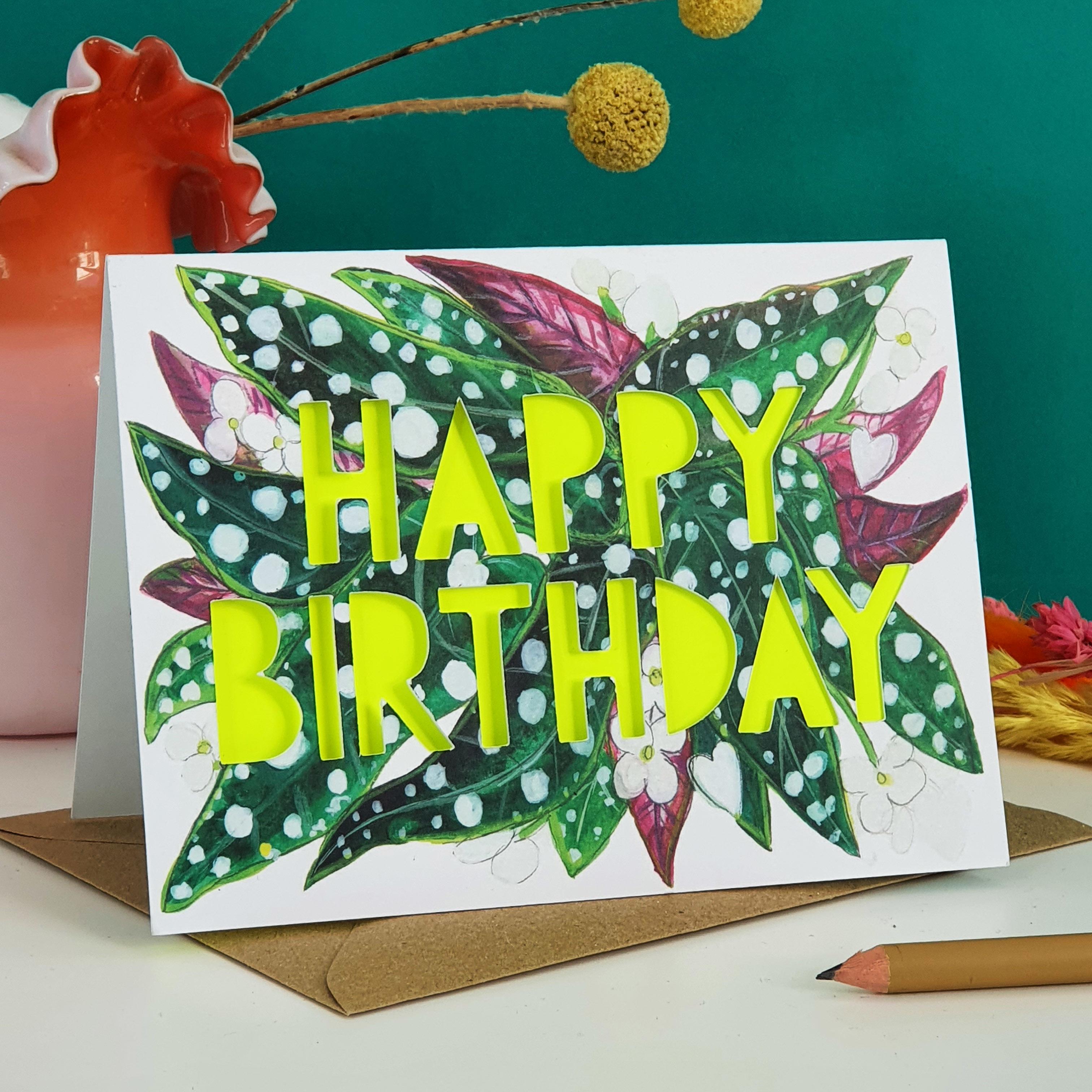 Paper cut card with 'Happy Birthday' typography on a printed spotty begonia 350 gsm card with neon yellow liner.