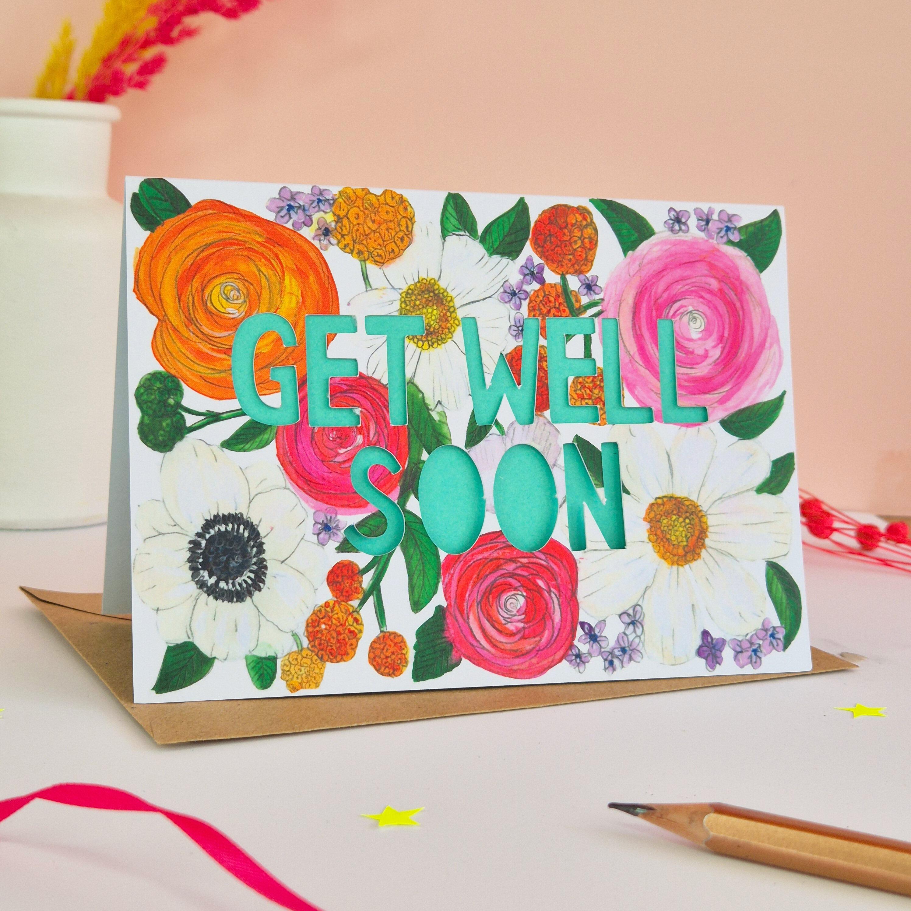 Get Well Soon card with bright floral illustration and paper cut text with bright turquoise backing paper