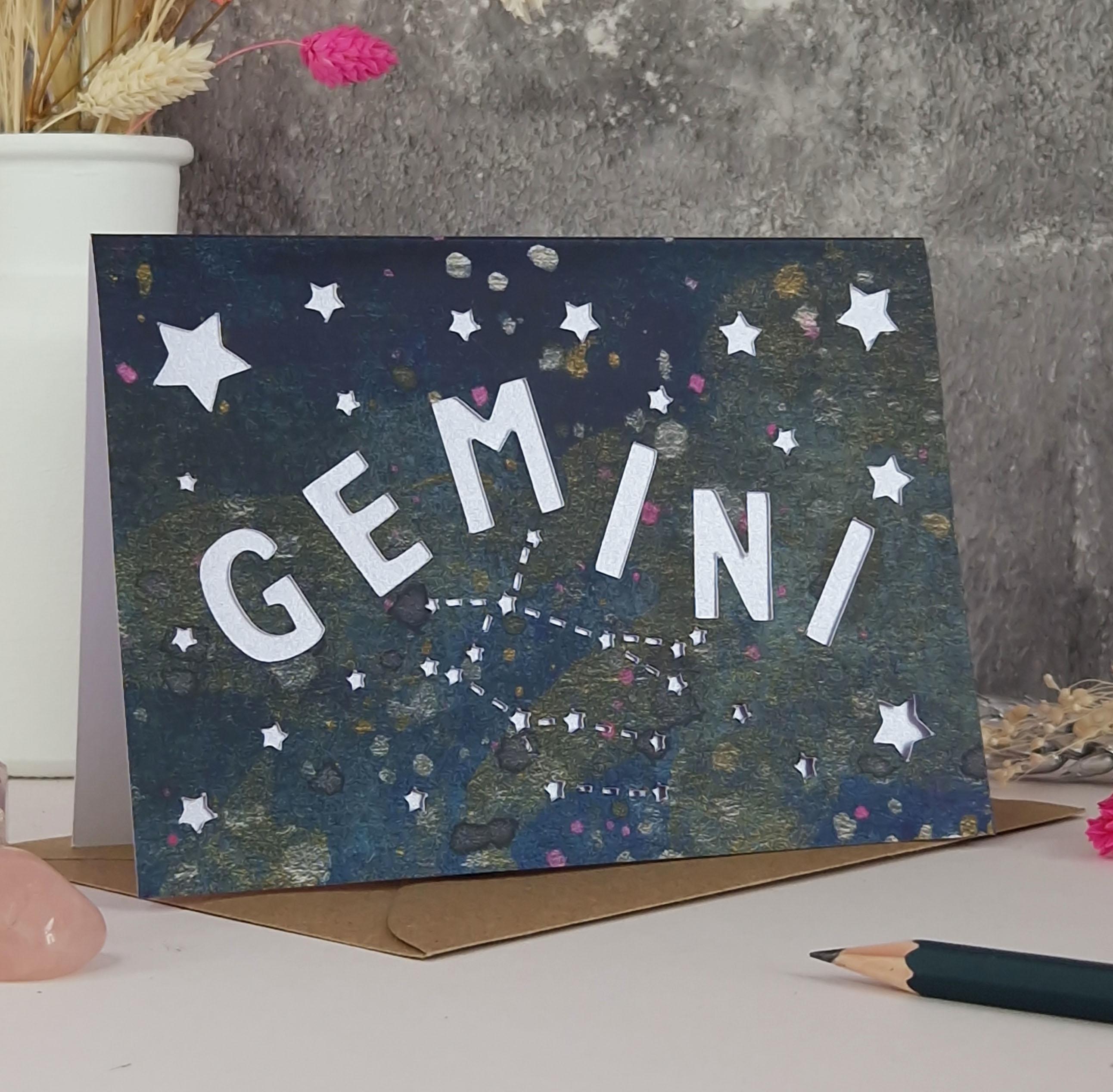 Midnight Blue printed card with papercut text that says 'Gemini' and a lilac pearl liner