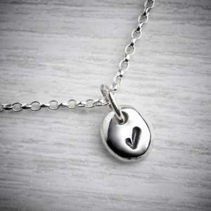 Handmade silver necklace, pebble with a tick by Emma White