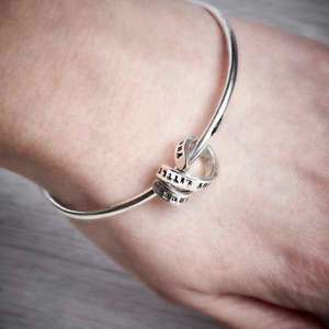 Silver Bangle with Personalised Story Spiral by Emma White, worn on.