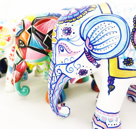 Painted model elephants in a line