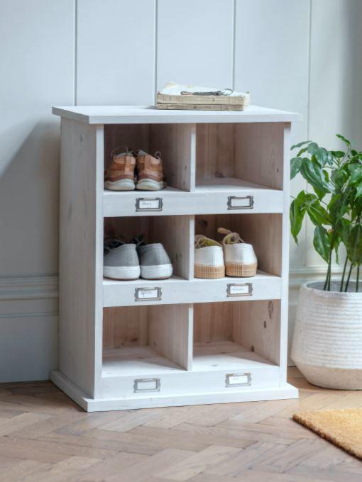 small wooden shoe storage unit in painted white wash finish