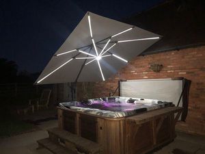 3m garden cantilever parasol grey with base over outdoor hot tub