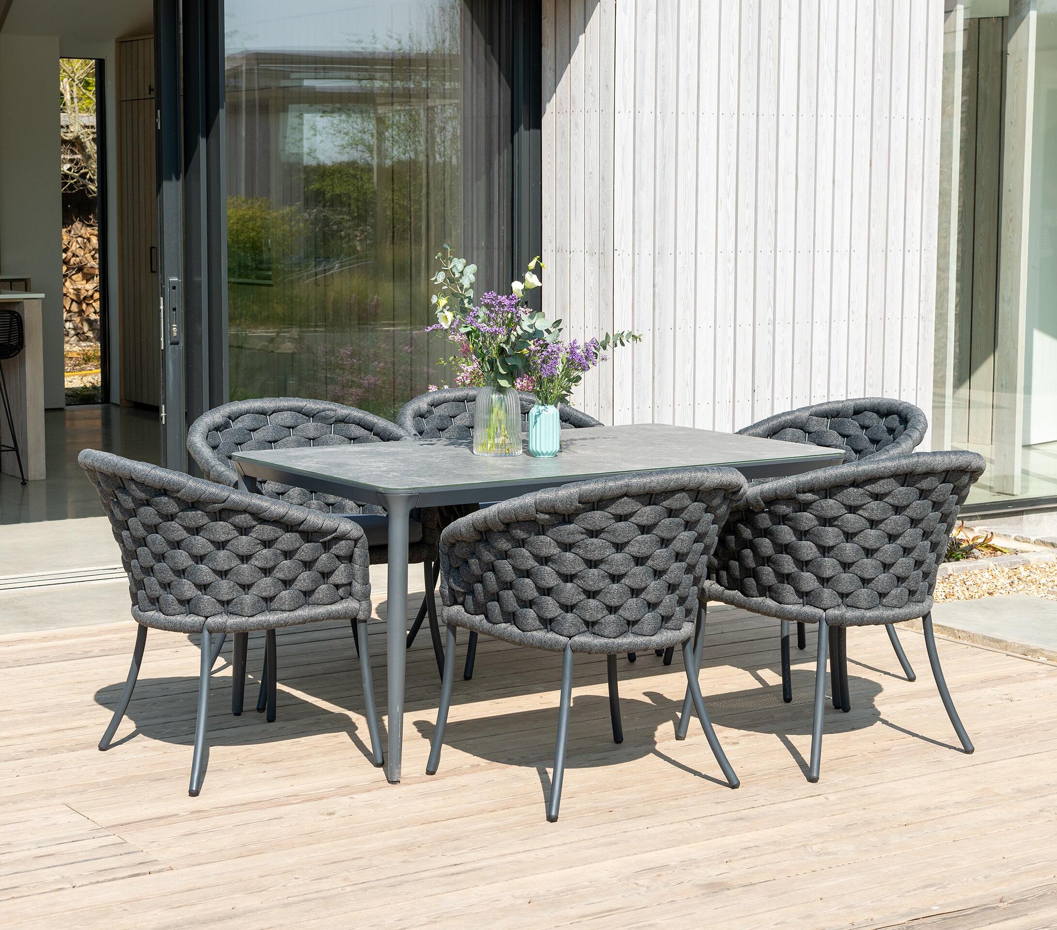 6 seater all weather wide braided rope weave garden dining chairs in dark grey with rectangle aluminium garden patio dining table