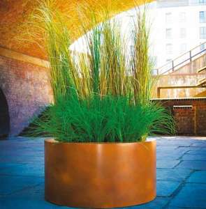 fibreglass round cylinder garden planter in corten steel metal effect volume planting or water feature pond