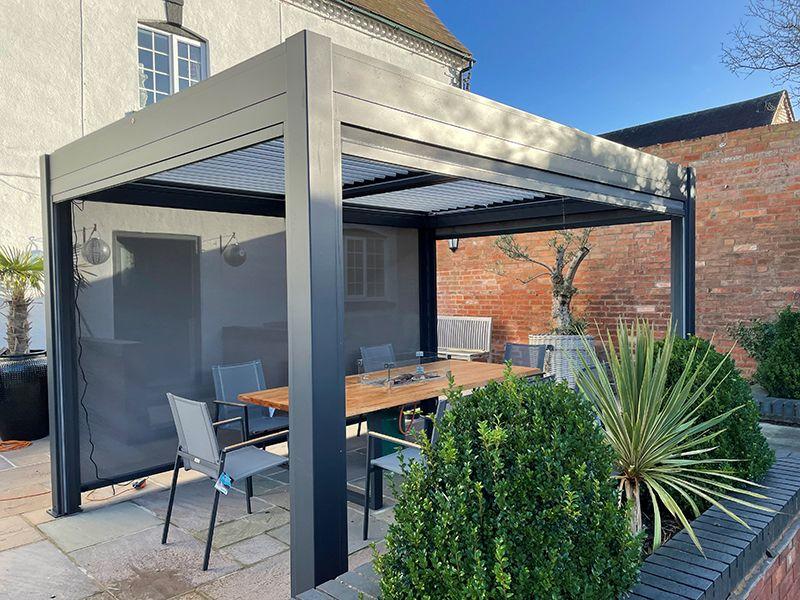 grey garden aluminium gazebo with side curtains, motorised louvre roof and led lights