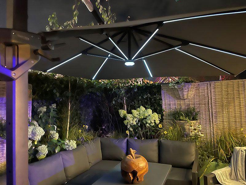 grey modern 3 m square cantilever garden parasol with led lights over patio dining set