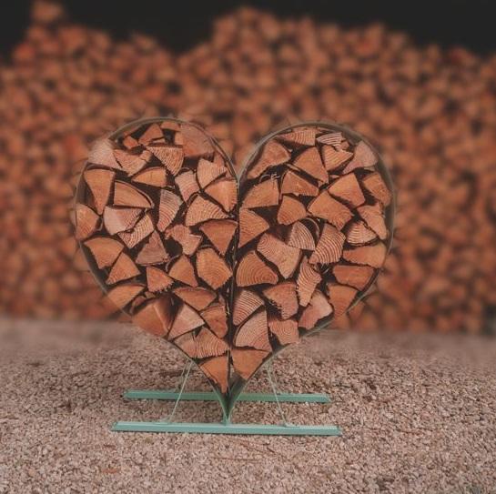 metal heart shaped log store in sage green for outdoor garden use