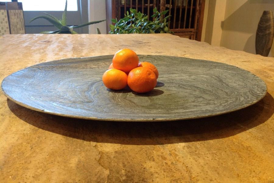 decorative slate dish with oranges on dining table