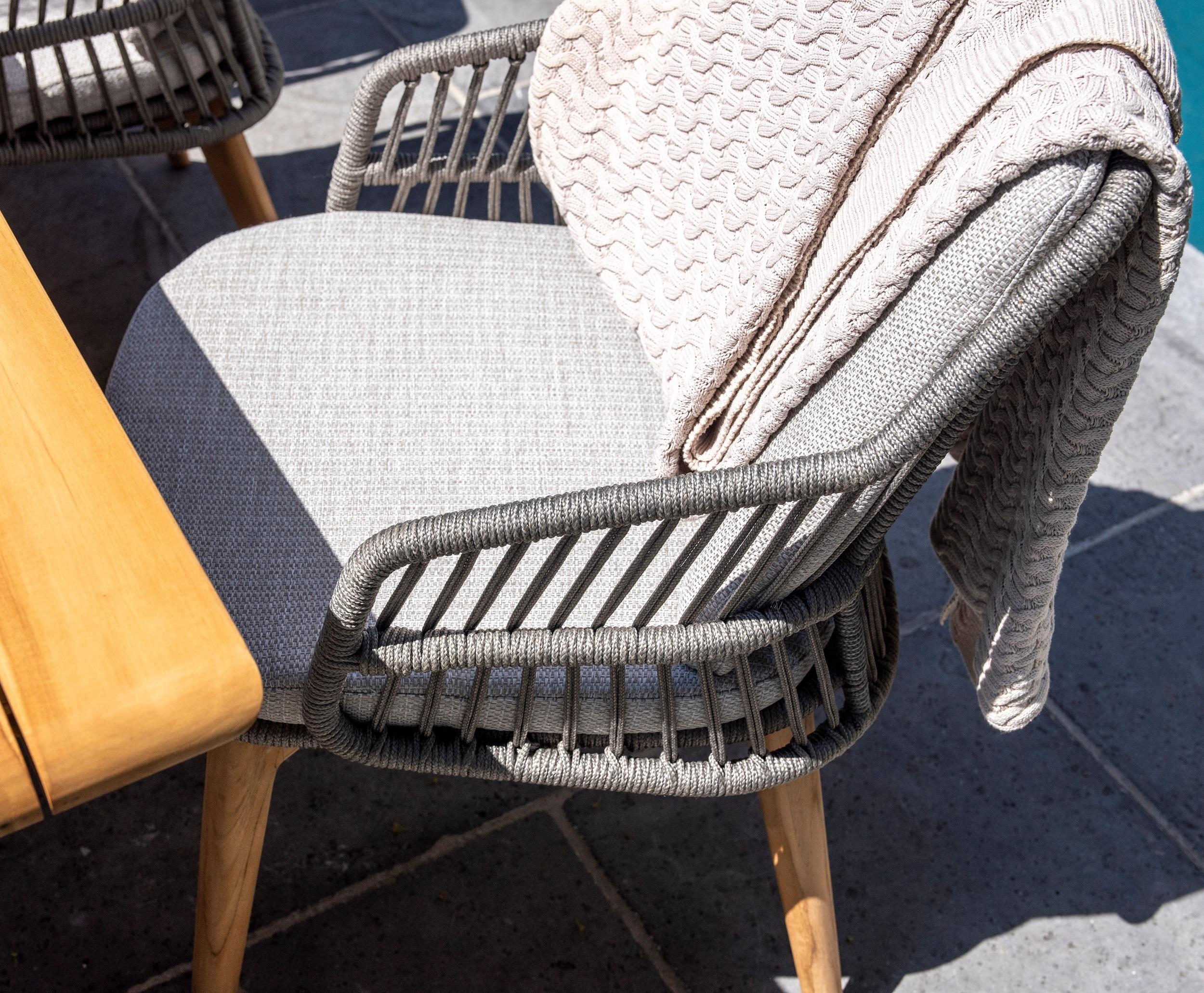 aerial view of garden dining chair in all weather rope weave and teak legs with grey cushions