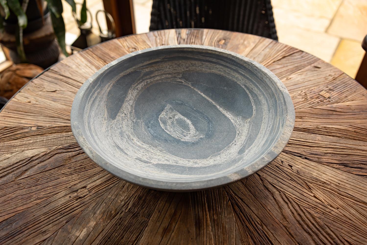 pewter sandstone bird bowl on oak table