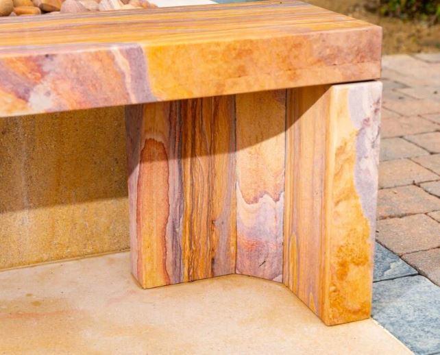 sandstone bench in rainbow natural stone cubist leg design detail