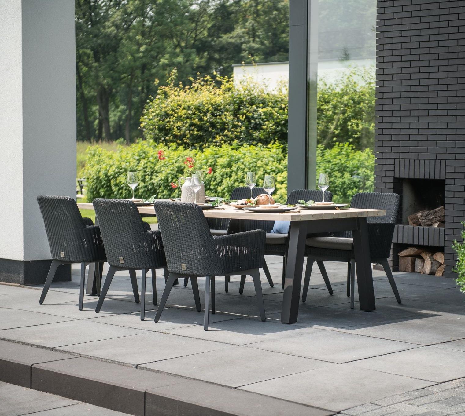 modern teak garden dining table with anthracite grey bucket rattan dining chairs aluminium legs