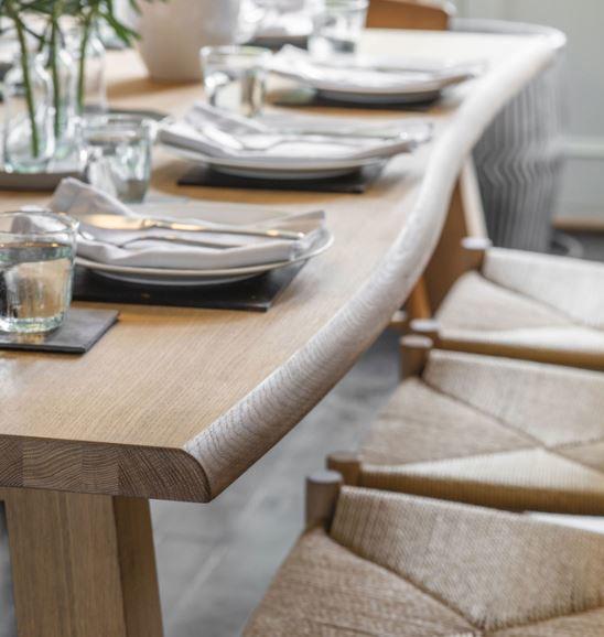 oak wavy edged design kitchen or dining table with woven seat oak dining chairs detail
