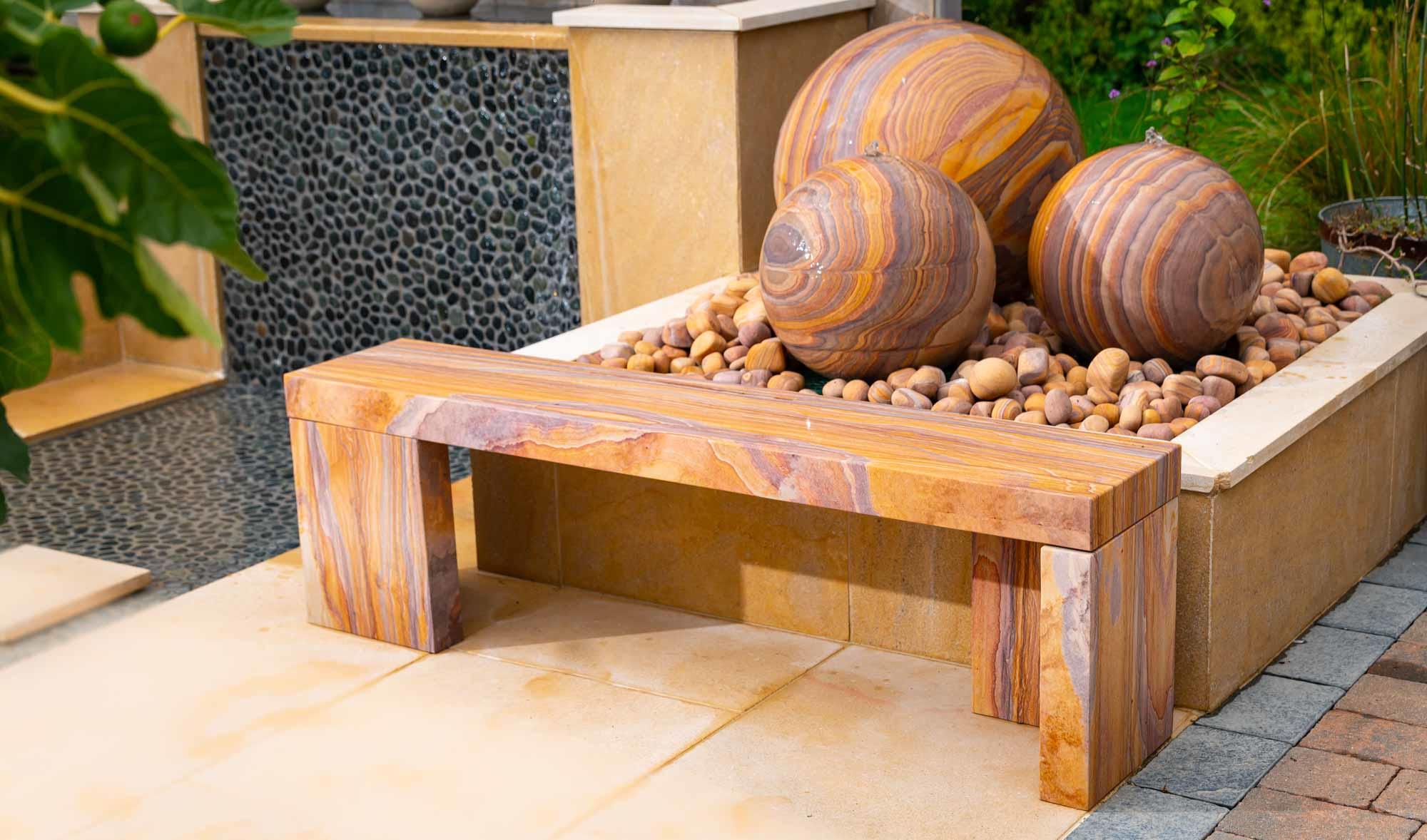 rainbow stone cubist design garden bench in natural sandstone