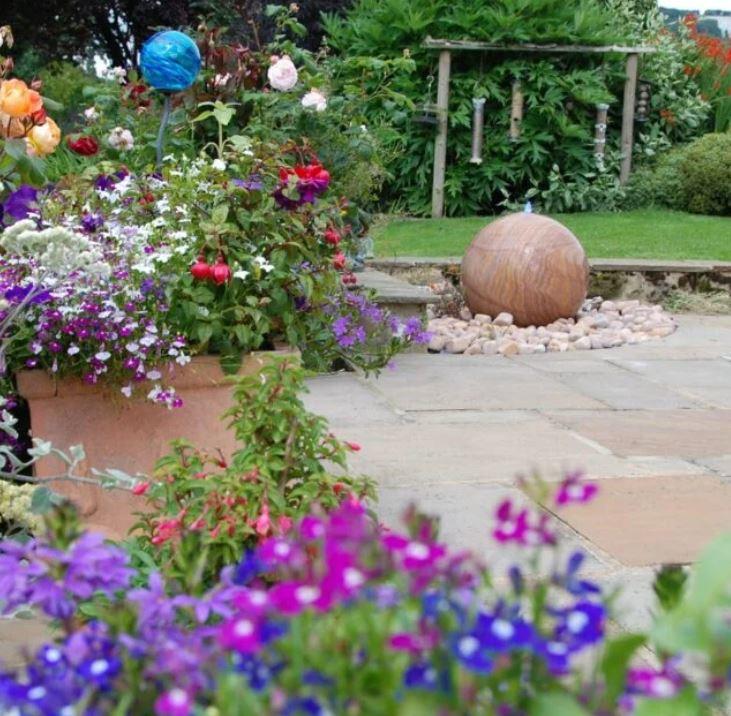 natural rainbow sandstone water ball in flower garden