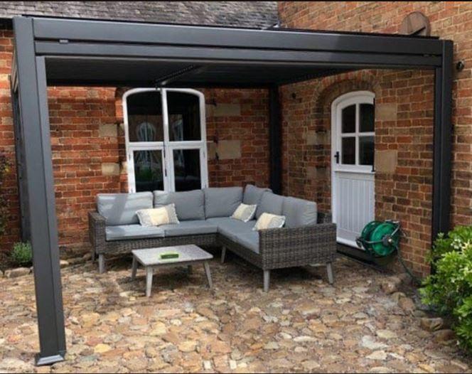 gazebo in grey aluminium outside country backdoor with louvre roof grey