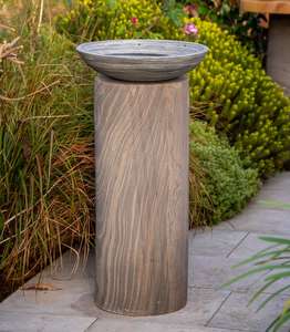 modern pewter grey sandstone bird bath or bird bowl on shark grey plinth