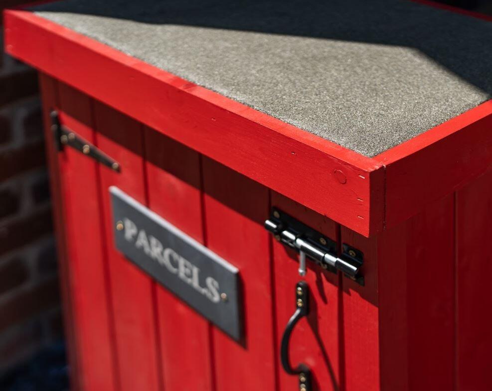 red painted wooden outdoor parcel box for post mail courier deliveries wooden timber fsc