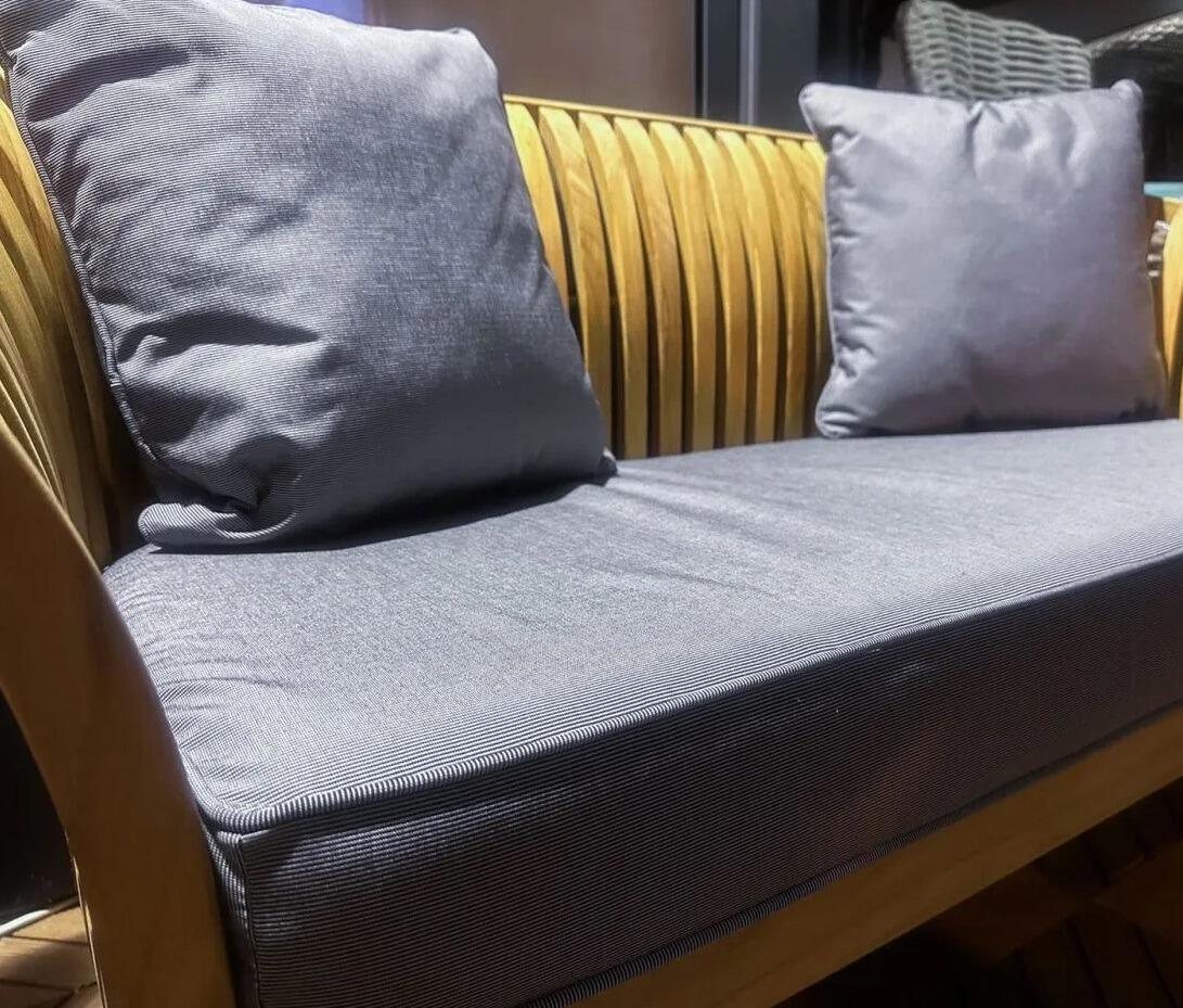 curved teak garden bench with all weather grey seat and scatter cushions spring slatted patio seat