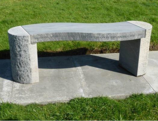 curved garden stone bench in honed and hammered grey sandstone