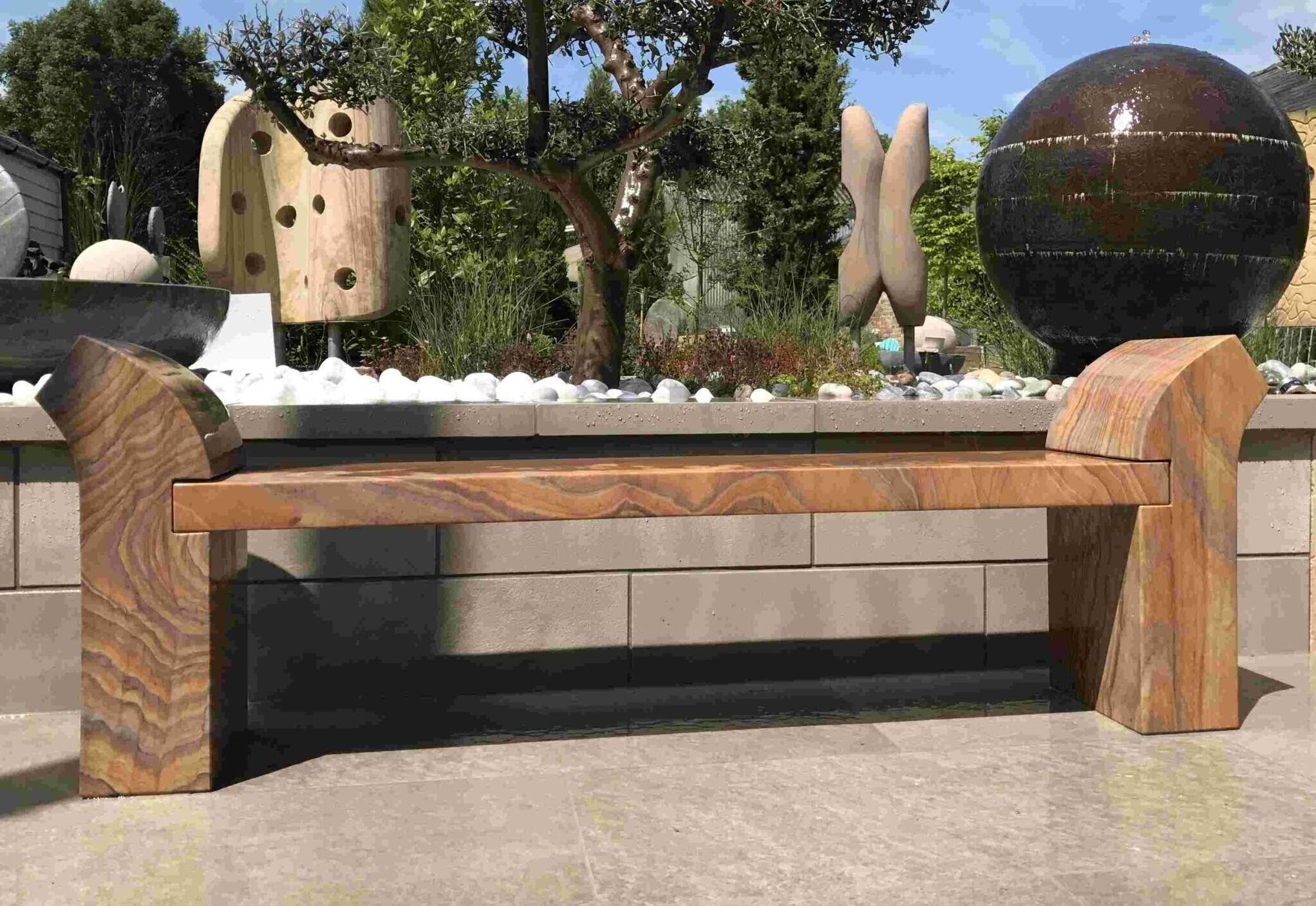 rainbow stone garden bench in natural sandstone with curved arms
