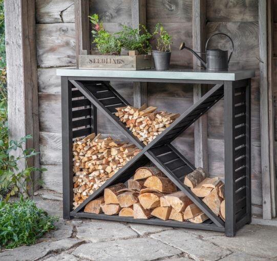 outdoor garden log store in blackened spruce with galvanised top shelf