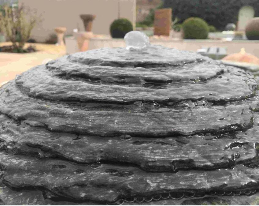 detail of layered slate garden water fountain