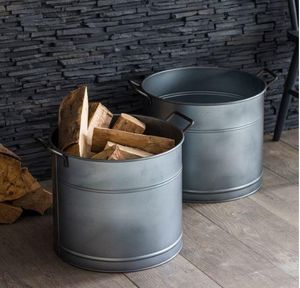 wood storage as pair of modern metal galvanised steel buckets or planters