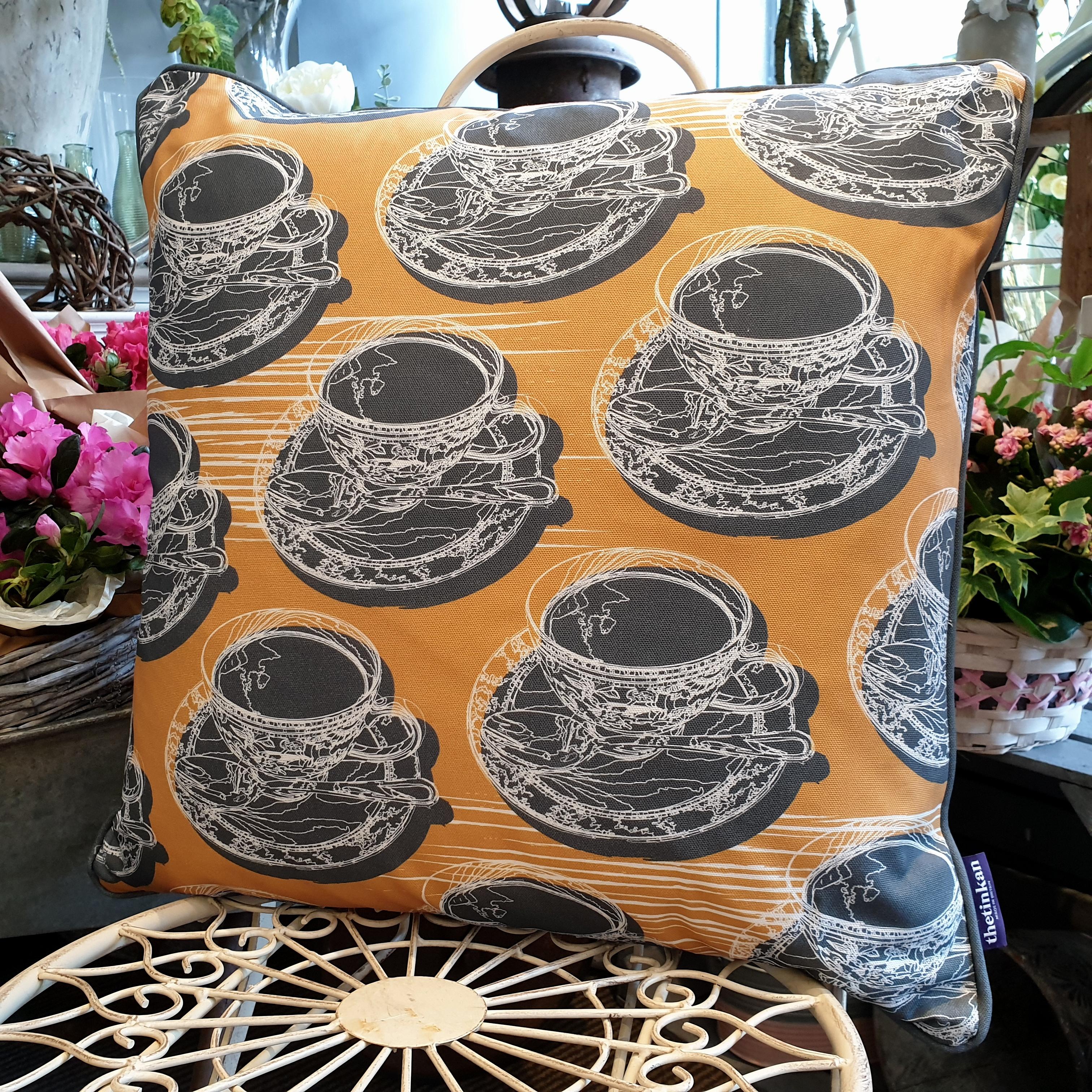 Double-sided mustard yellow 51cm square retro Afternoon Tea cushion with artistic white shards and grey handcrafted piping designed by thetinkan. White traced outline of multiple British teacups and saucers each colour filled in charcoal grey. Available with an optional luxury cushion inner pad. VIEW PRODUCT >>