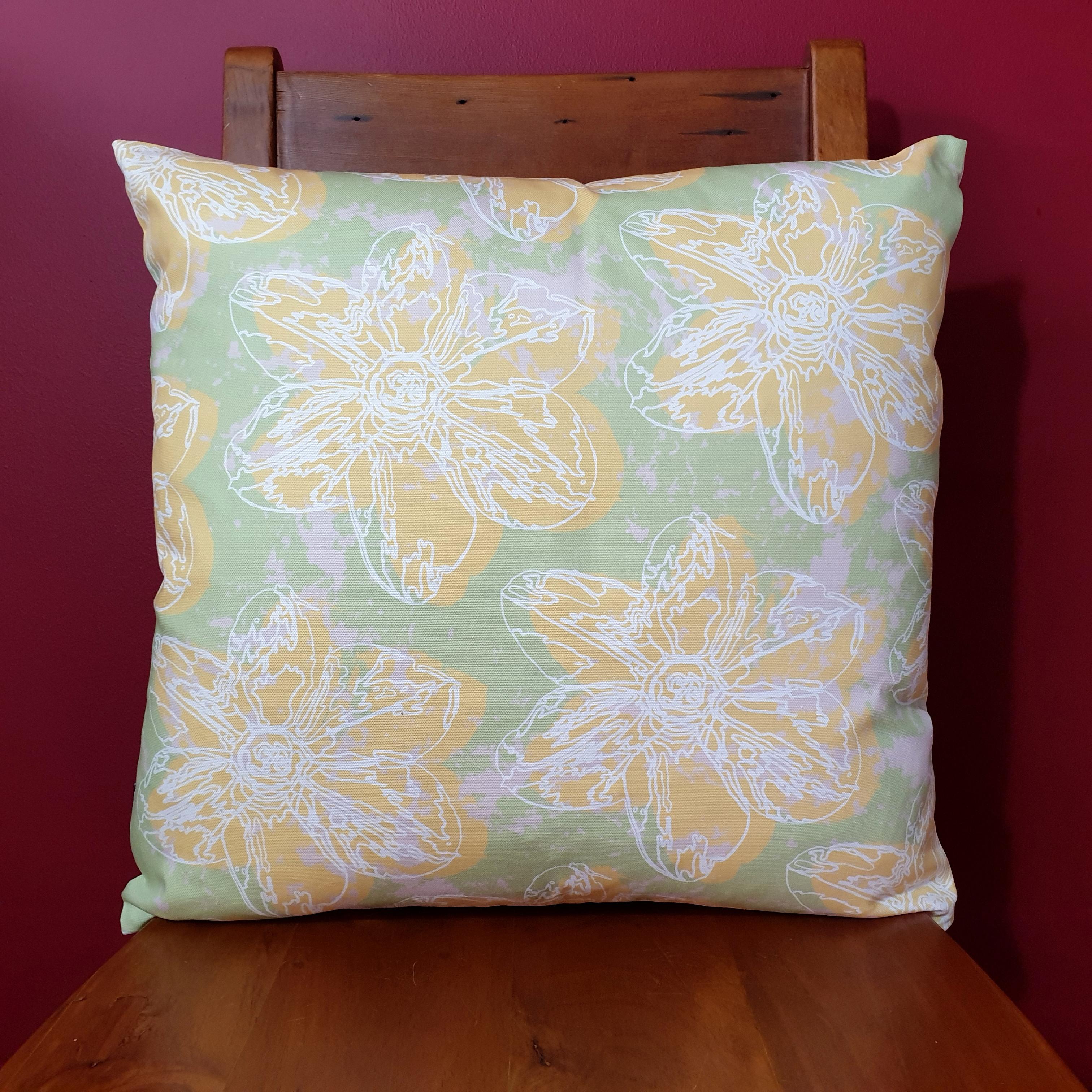 Double-sided 51cm square Flower Splash cushion designed by thetinkan. Yellow narcissus flower with white traced outline set within a mint green background with pale pink paint splashes. Available with an optional luxury cushion inner pad. VIEW PRODUCT >>