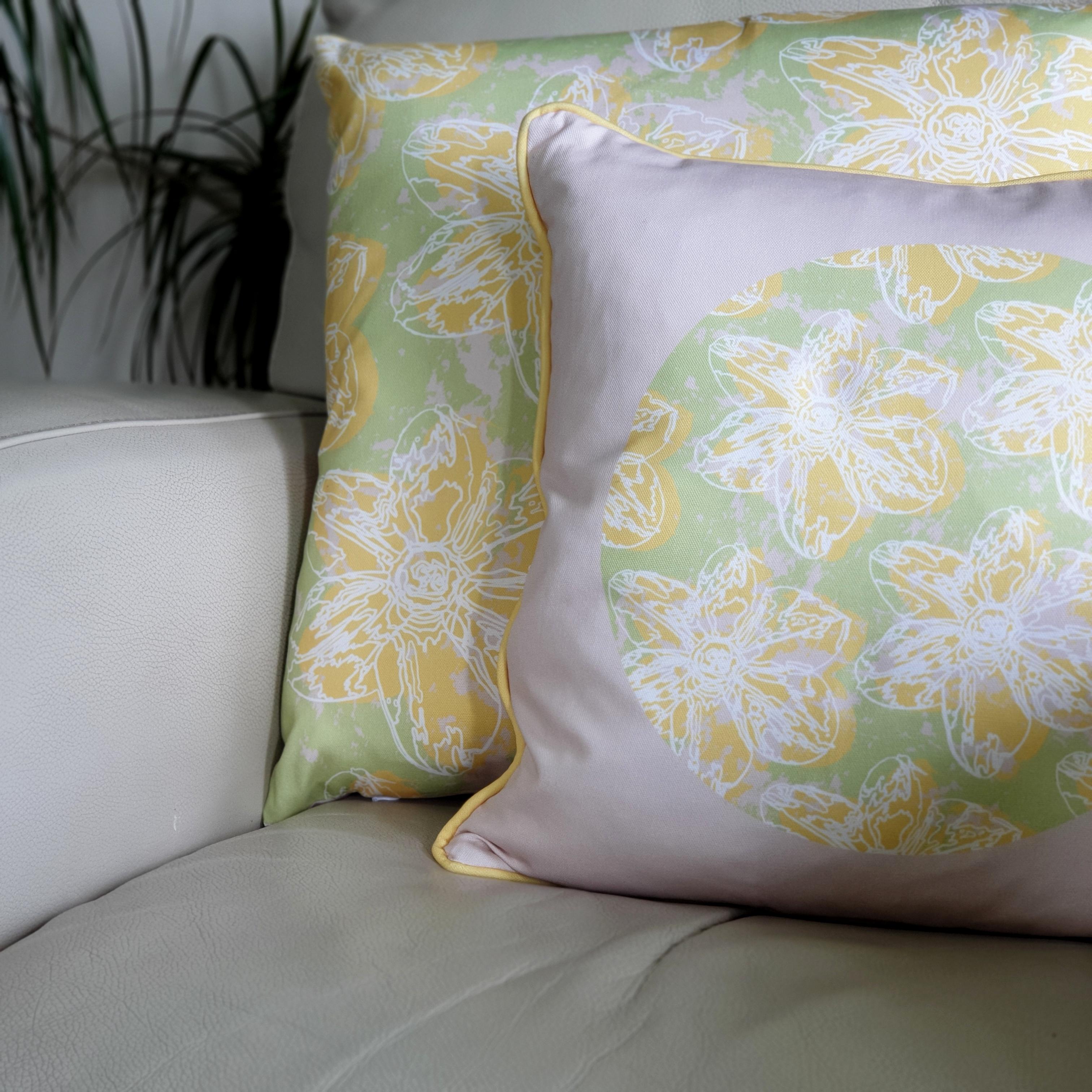 Double-sided 45cm square & 51cm square Flower Splash cushions, showing both sides, designed by thetinkan. Yellow narcissus flower with white traced outline set in a mint green coloured circle with pale pink paint splashes and pale pink surround. Available with an optional luxury cushion inner pad. VIEW PRODUCT >>