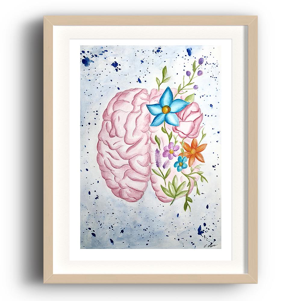 A watercolour print by Clarrie-Anne on eco fine art paper titled Mindfulness showing a brain with flowers surrounding it. The image is set in a beech coloured picture frame.