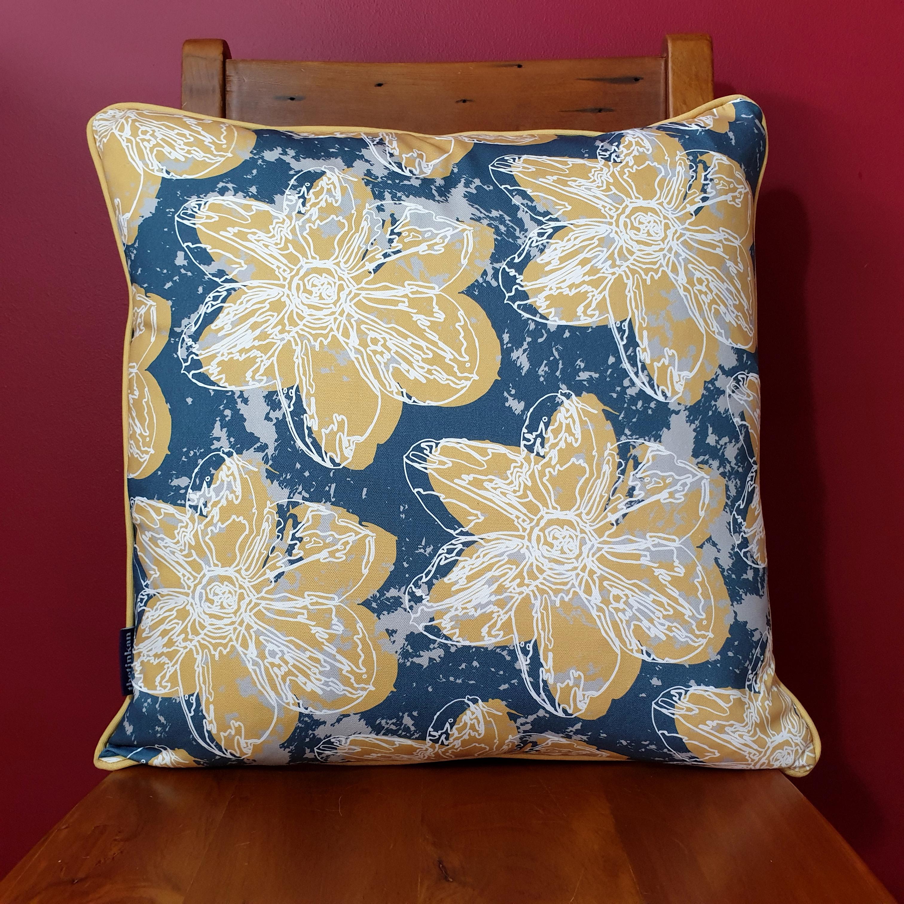 Double-sided 51cm square Flower Splash cushion designed by thetinkan. Mustard yellow narcissus flower and mustard yellow piping with white traced outline set within an oxford blue background with pale grey paint splashes. Available with an optional luxury cushion inner pad. VIEW PRODUCT >>