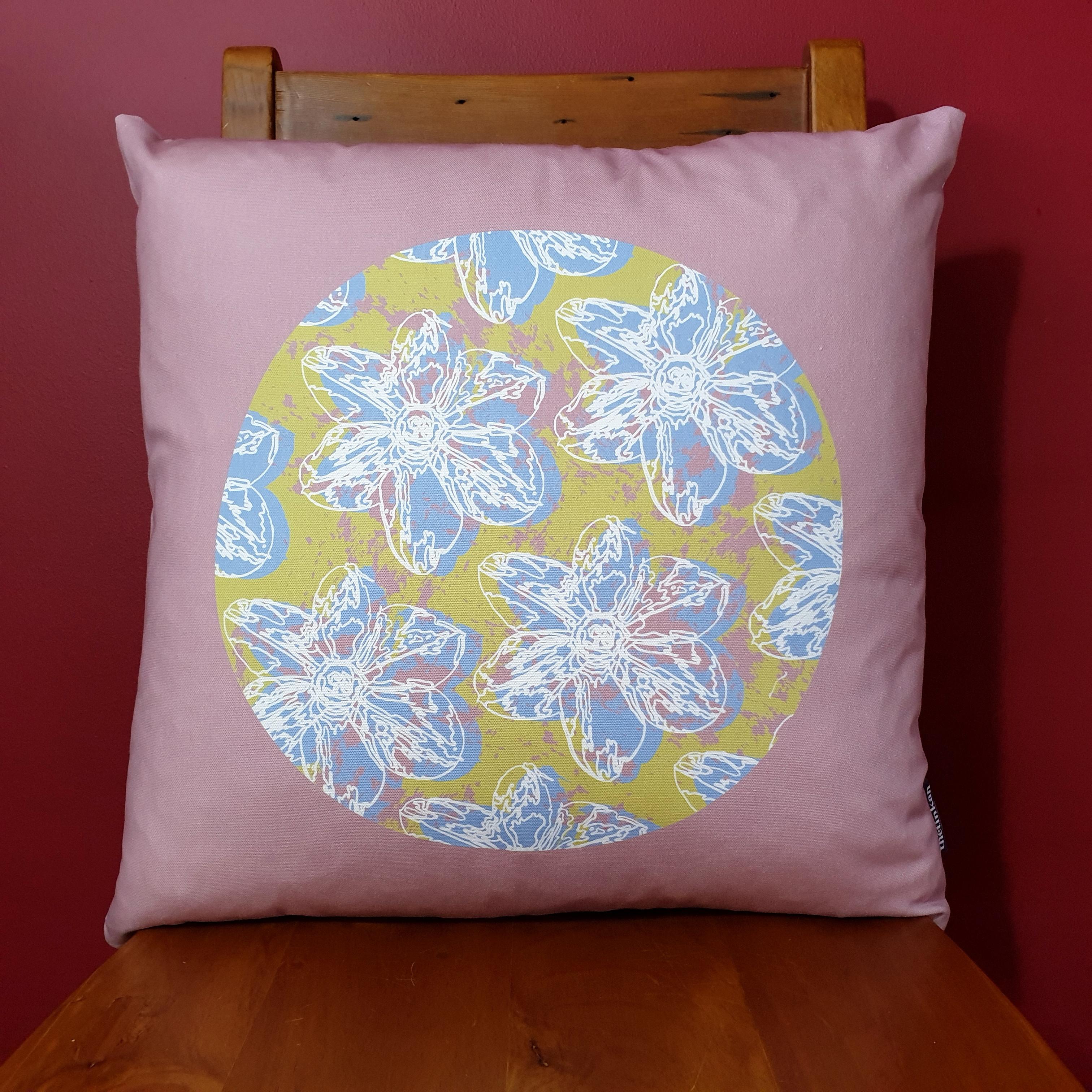 Double-sided 51cm square Flower Splash cushion designed by thetinkan. Pale Blue narcissus flower with white traced outline set in a light olive green coloured circle with salmon pink paint splashes and salmon surround. Available with an optional luxury cushion inner pad. VIEW PRODUCT >>