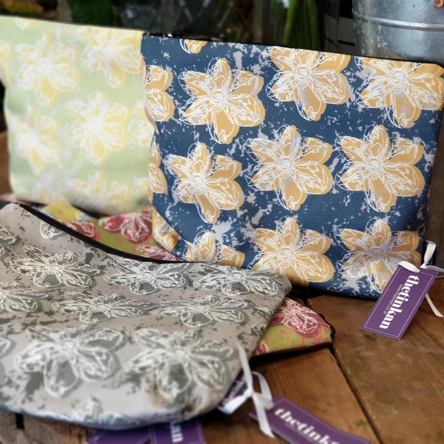 A generously sized travel beauty washbag featuring the white traced outline of a narcissus flower. Available in six colours and made from panama cotton with black waterproof lining and matching black sturdy zip. Suitable for all your travel or home needs. Designed by thetinkan. VIEW PRODUCT >>
