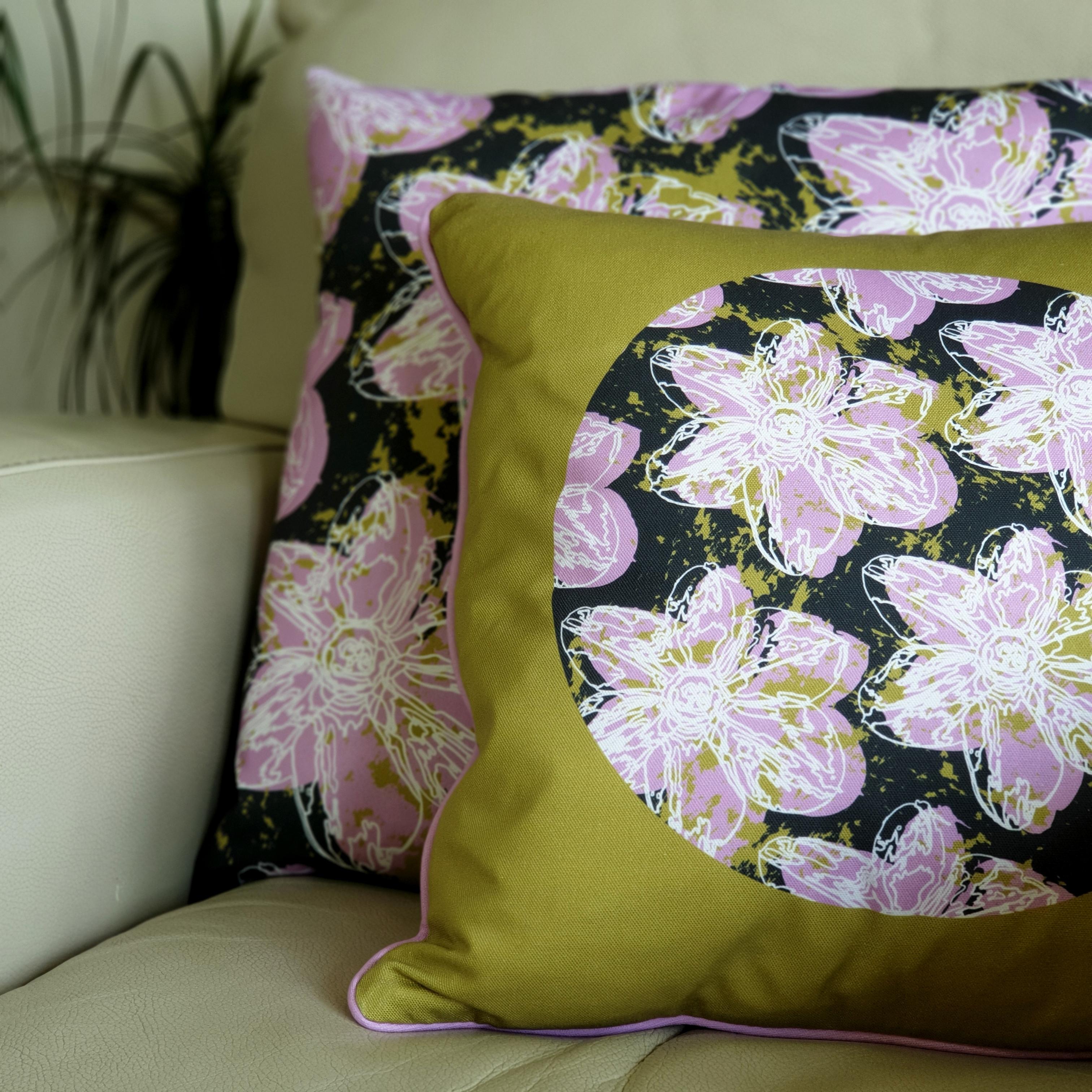 Double-sided 45cm square & 51cm square Flower Splash cushions, showing both sides, designed by thetinkan. Candy pink narcissus flower with white traced outline set within a dark charcoal grey background with olive green paint splashes. Available with an optional luxury cushion inner pad. VIEW PRODUCT >>