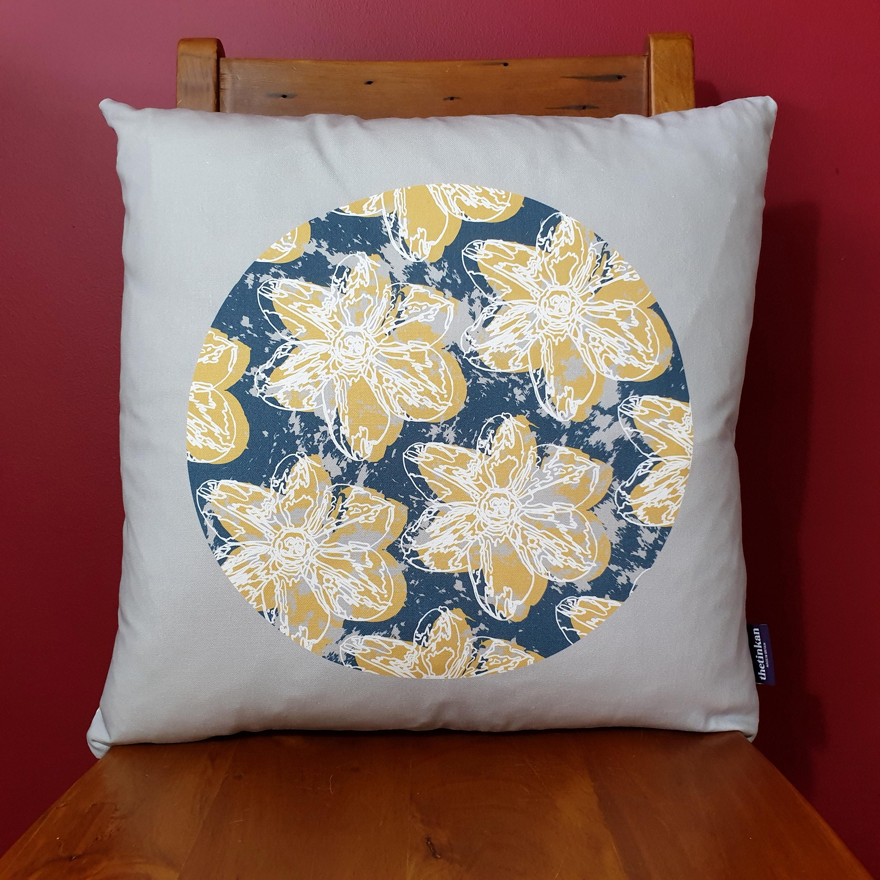 Double-sided 51cm square Flower Splash cushion designed by thetinkan. Mustard yellow narcissus flower with white traced outline set in an oxford blue coloured circle with pale grey paint splashes and pale grey surround. Available with an optional luxury cushion inner pad. VIEW PRODUCT >>