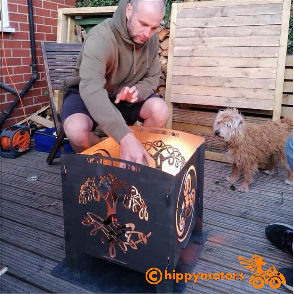 Portable firepit being used on decking