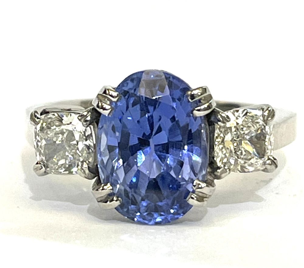 Sri Lankan sapphire 5.54ct and cushion cut diamond three stone ring