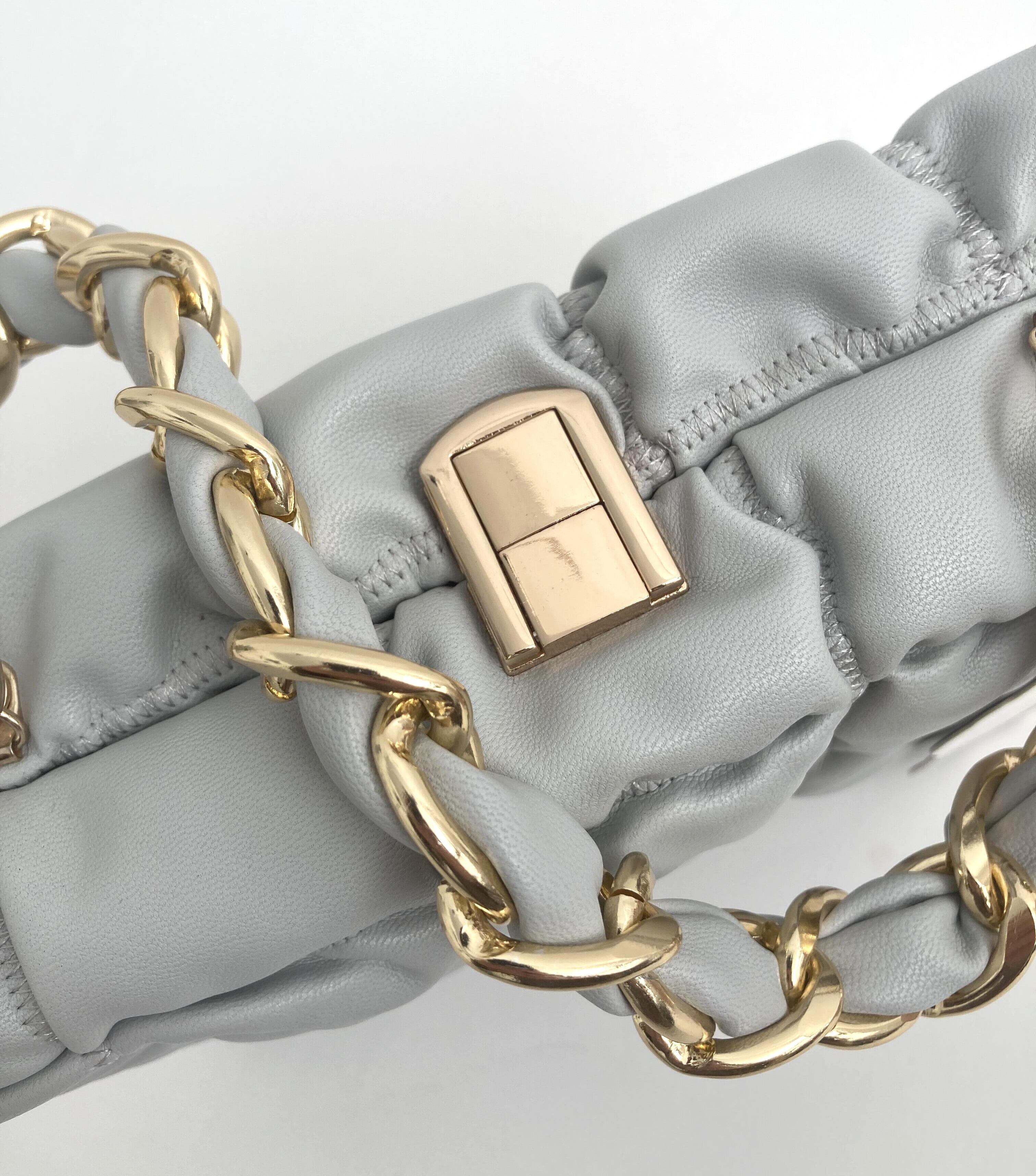 close up of the faux leather quitted clutch bag in grey