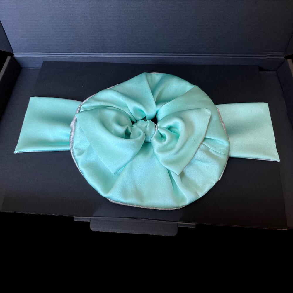 Aquamarine blue silk scrunchie and headband displayed in a black gift box.
